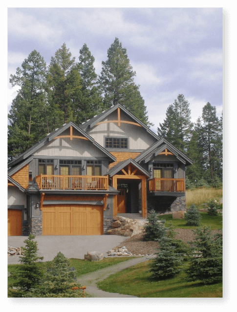 A large alpine styled house surrounded by trees